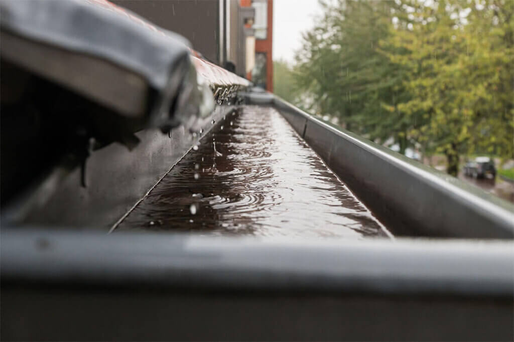Rainwater flowing through a commercial rain gutter in Excelsior, MN.